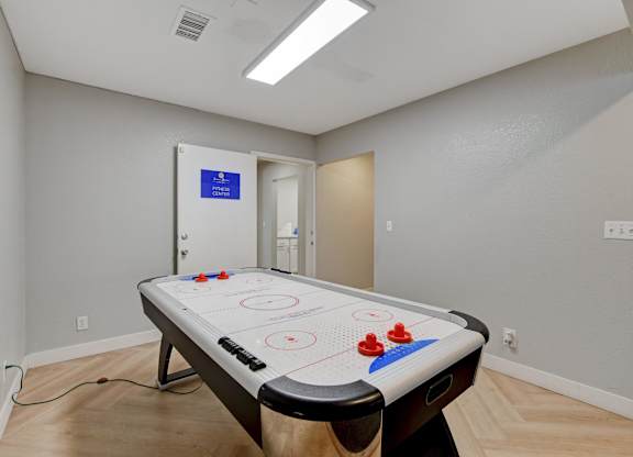 A pool table in a room with a blue sign on the door.