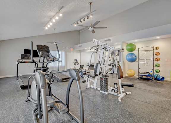 A home gym with a variety of exercise equipment.