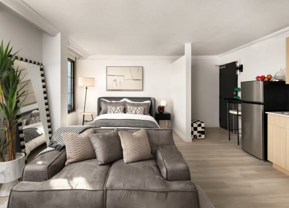 a bedroom with a couch and a bed and a kitchen at Vision on Lombard, Baltimore, MD 21201