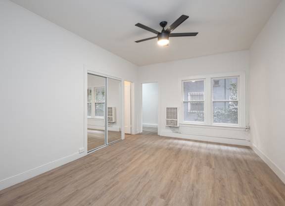 A room with a ceiling fan and a window at Westmore Manor Apartments, Los Angeles, CA, 90020