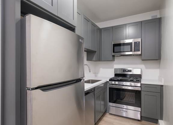 A modern kitchen with a stainless steel refrigerator and oven at Westmore Manor Apartments, Los Angeles, 90020