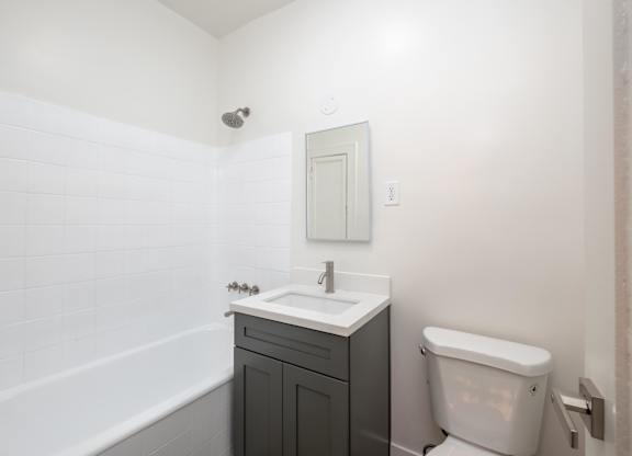 A white sink with a silver faucet and a white toilet in a bathroom at Westmore Manor Apartments, California, 90020