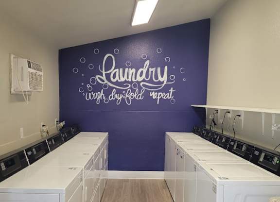 Laundry room with washers and dryers.
