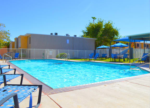 a swimming pool at a hotel with chairs and umbrellasat Summer Meadows, Las Vegas