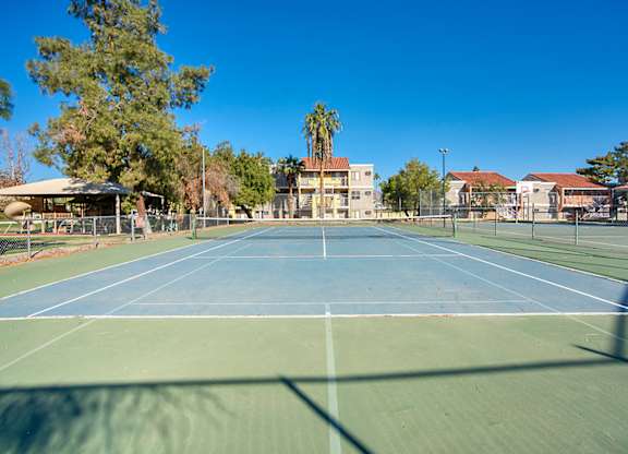 A tennis court with a blue sky in the background.