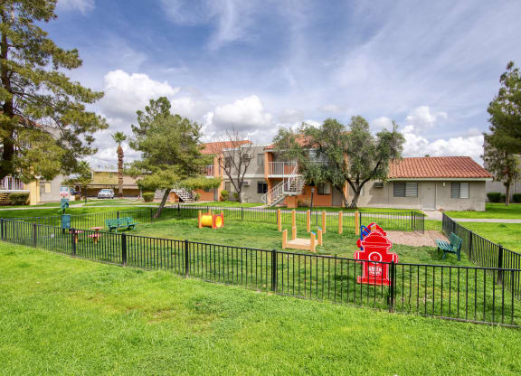 a playground with a fire hydrant in the middle of a grassy area at Valencia Park, Phoenix, Arizona, 85008