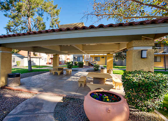 A patio area with a large planter in the center.