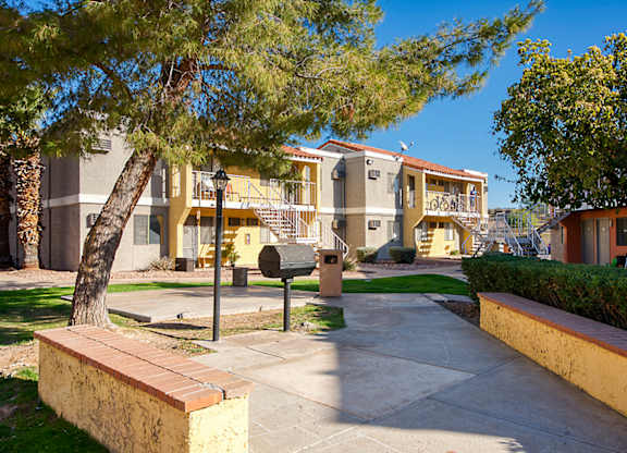A tree in a courtyard of apartment buildings.