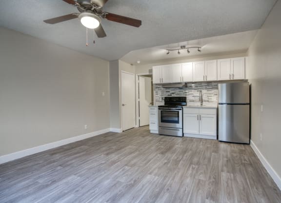 an open living room and kitchen with a ceiling fan at Valencia Park, Phoenix, Arizona