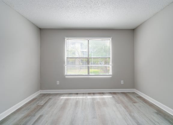 an empty room with wood floors and a window at Village Lakes, Orlando, FL, 32808