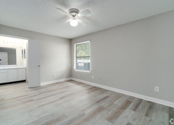 an empty living room with a ceiling fan and a window at Village Lakes, Orlando, FL, 32808