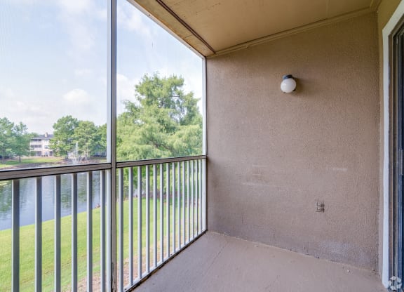 a balcony with a view of a river and trees at Village Lakes, Orlando, FL, 32808
