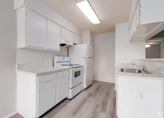a white kitchen with white appliances and white cabinets at Village Lakes, Orlando, FL, 32808