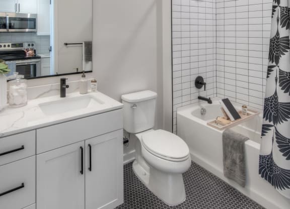 Bathroom with white vanity, and a tub/shower combo