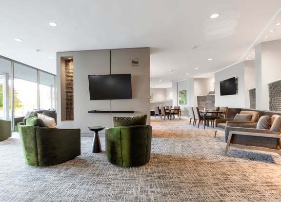 a living room with couches and chairs and a television