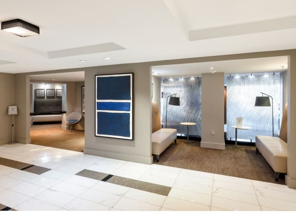 a lobby of a hotel with a reception area and a living room