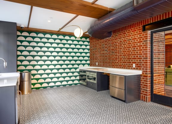 a kitchen with green and white wallpaper and stainless steel appliances