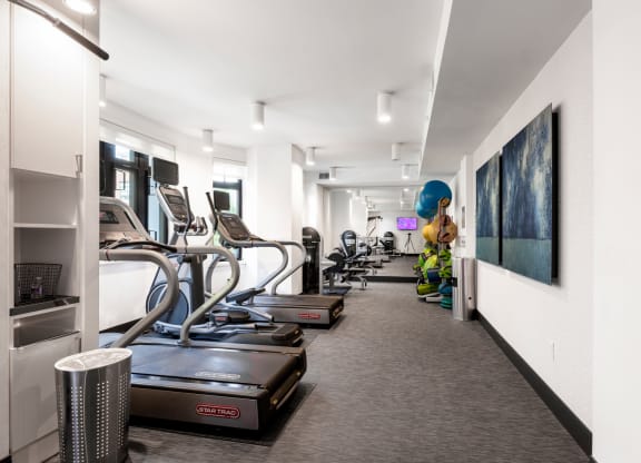 a gym with treadmills and other exercise equipment