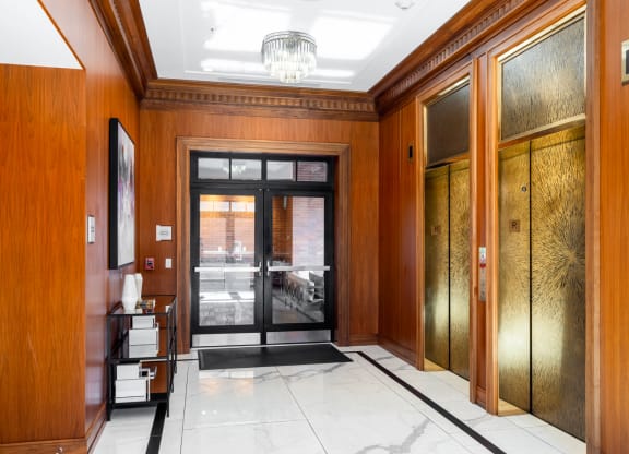 a view of a hallway with wood paneling and a glass door
