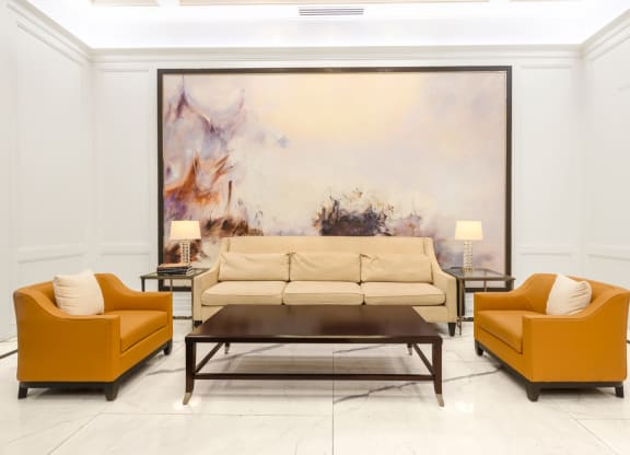 a living room with a large painting on the wall behind the couch