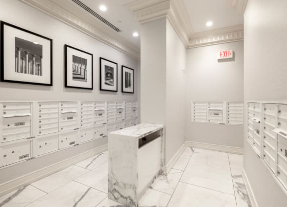 a mail room with white cabinets and a marble podium