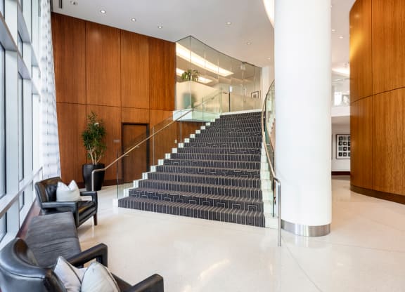 the lobby of a building with a large staircase and furniture at 220 Twentieth Street, Arlington, VA