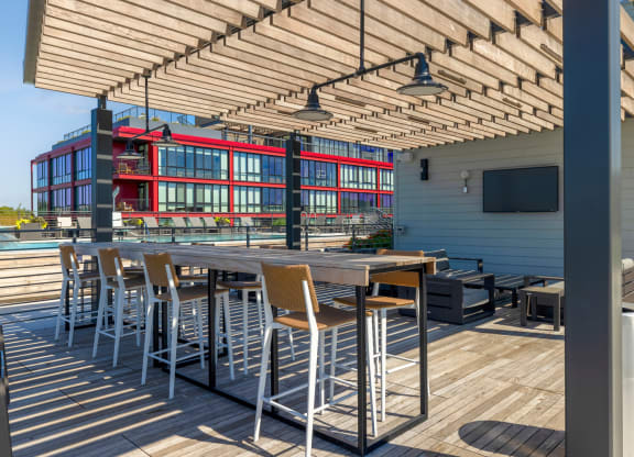 a patio with tables and chairs and a building in the background