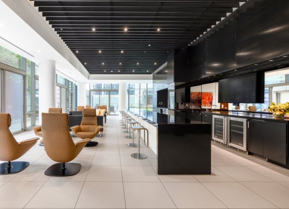 the lobby of a hotel with chairs and a bar