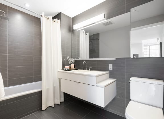 a bathroom with a sink and a toilet and a mirror