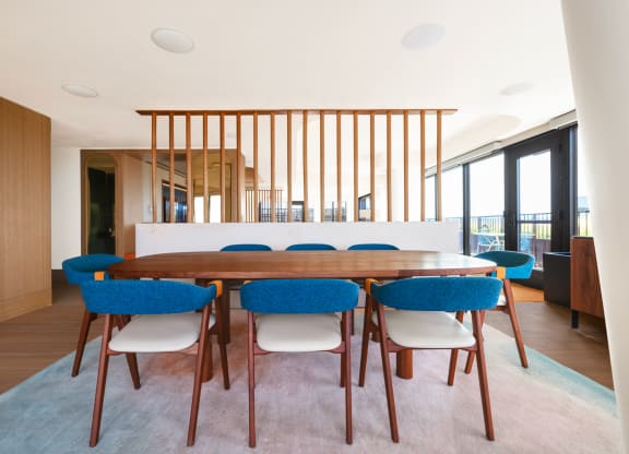 a large dining room with blue chairs and a wooden table at The Grace and Reva, Arlington