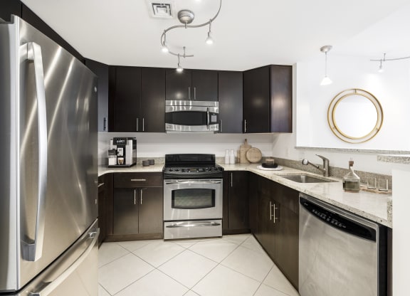 a kitchen with stainless steel appliances and black cabinets  at 220 Twentieth Street, Virginia