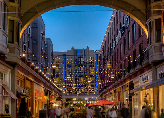 A busy street market is bustling with people shopping and dining.