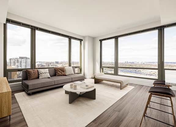 A modern living room with a large window overlooking the city.