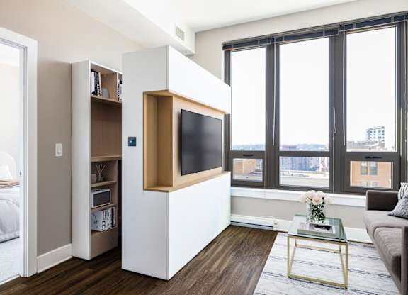 A modern living room with a television built into a cabinet.