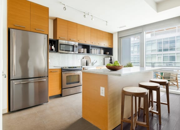 a kitchen with wooden cabinets and stainless steel appliances