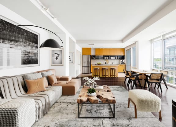 a living room and dining room with white walls and wood floors