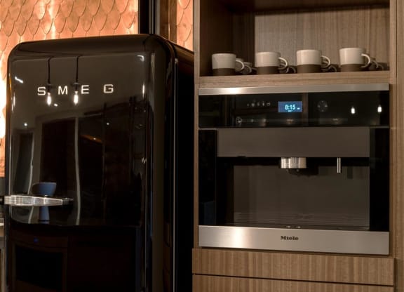 a black microwave oven sitting next to a black refrigerator