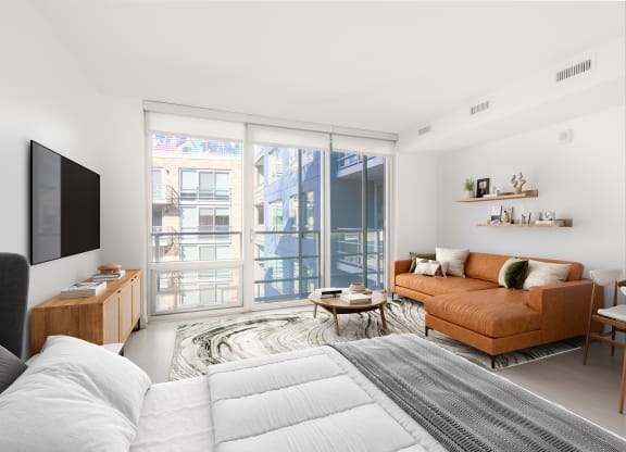 a bedroom with a bed and a couch in a room