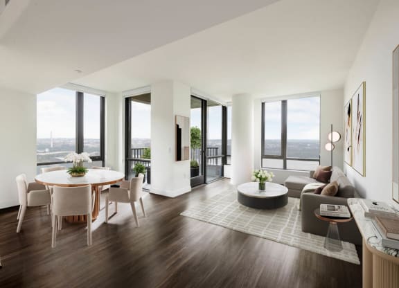a living room and dining room in a building with floor to ceiling windows at The Grace and Reva, Arlington, 22202