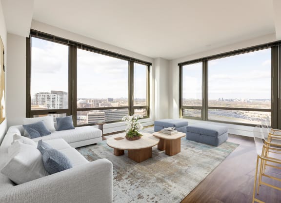 a living room with a large window and a view of the city  at The Bartlett, Arlington, Virginia