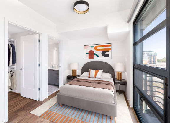 a bedroom with a large bed and a large window