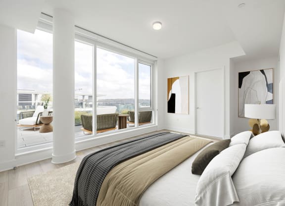a bedroom with a large bed and a large window