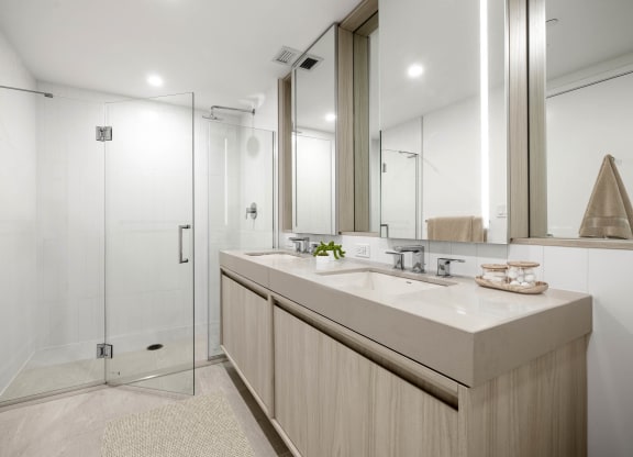 a bathroom with a large mirror and a glass shower