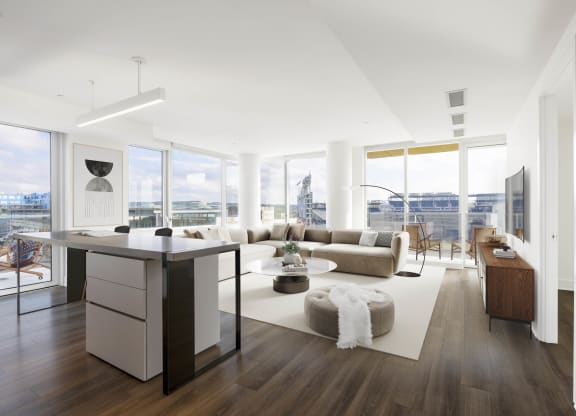 an open living room with white walls and hardwood flooring