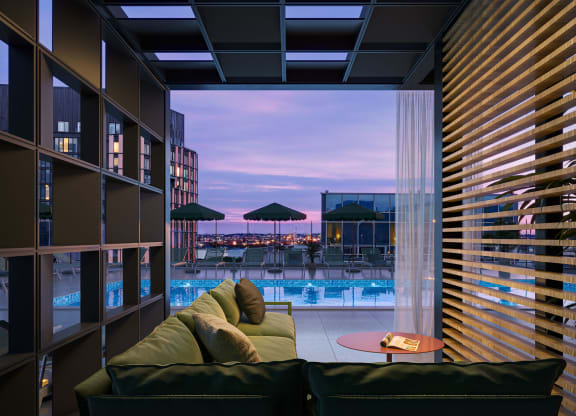 a living room with a couch and a view of a swimming pool