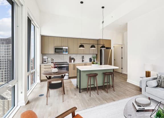 a living room with a kitchen and a table with chairs
