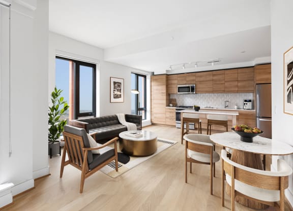 an open living room with a kitchen and a table at The Grace and Reva, Arlington, VA