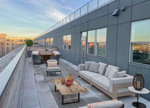 a terrace with couches and tables on a roof top