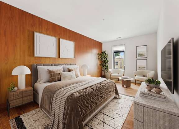 A bedroom with a large bed and a flat screen TV.