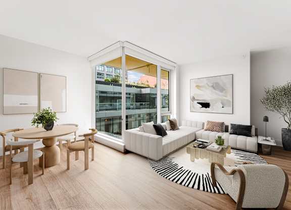 A living room with a white sofa, a wooden table and a zebra print rug.